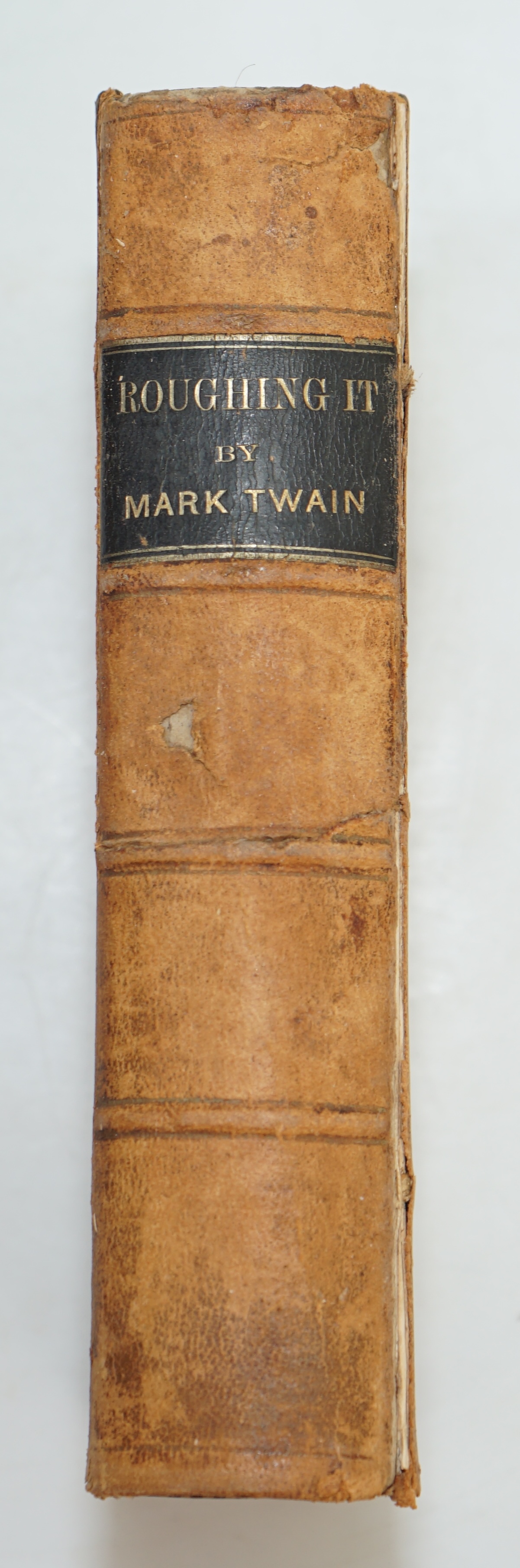 Twain, Mark [Samuel L. Clemens] - Roughing it, 8vo, calf, backstrip torn, boards scuffed, front inner hinge weak, front fly leaf with ink ownership inscription - ‘’John R. Baldwin, Christmas 1872’’, American Publishing C